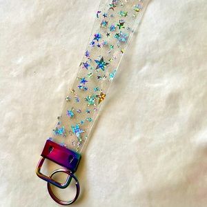 Clear holographic star jelly wristlet key fob with purple multicolor hardware.